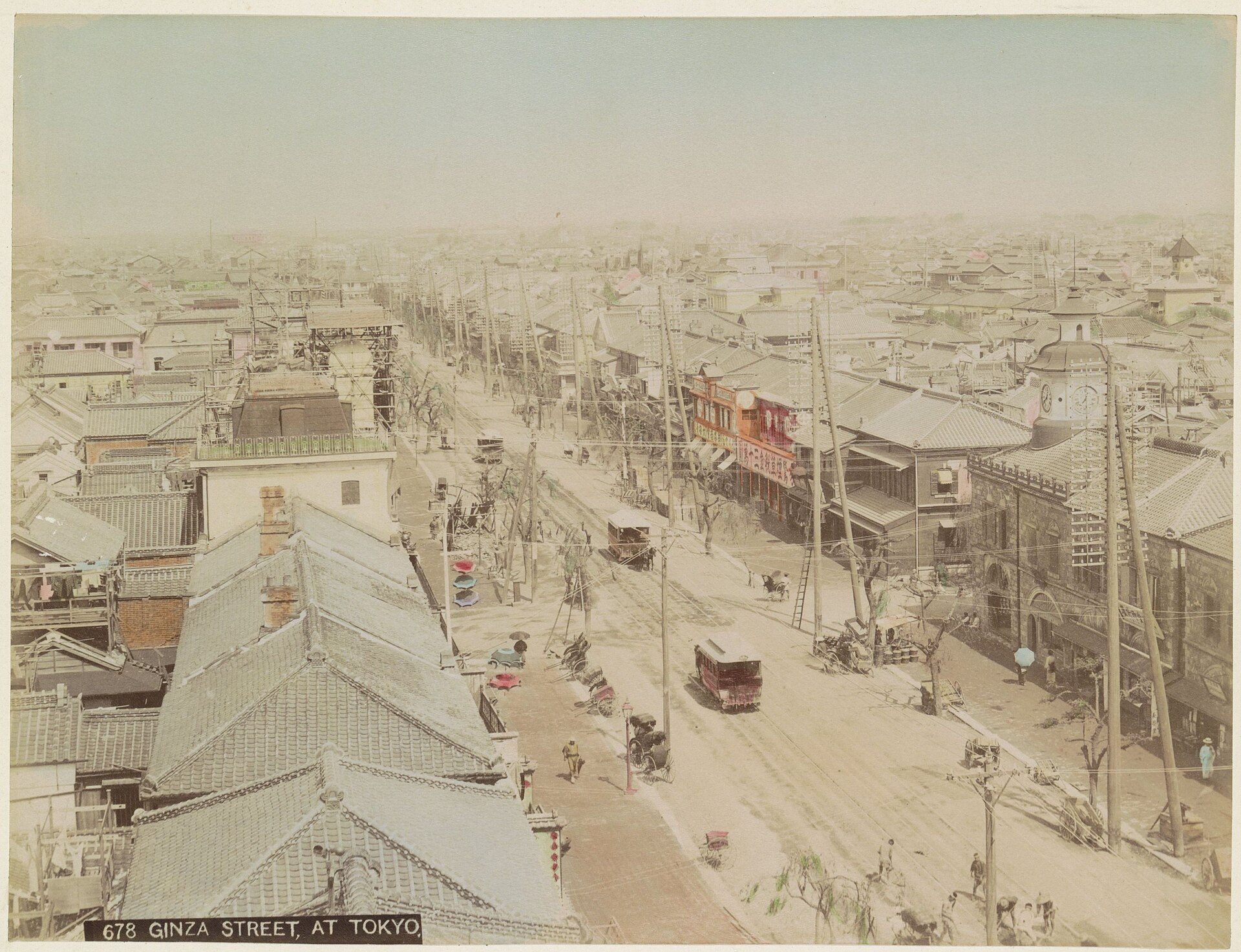 Historic Ginza street with horse trams, rickshaws, brick buildings and telegraph poles in the late nineteenth century