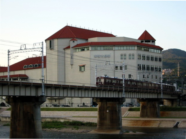 A Hankyu train passing Takarazuka Grand Theater in Hyogo