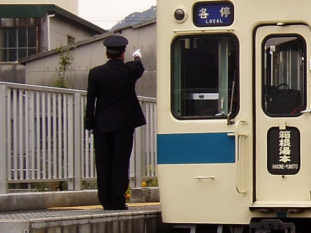An Odakyu conductor performing a safety check at Kazamatsuri Station