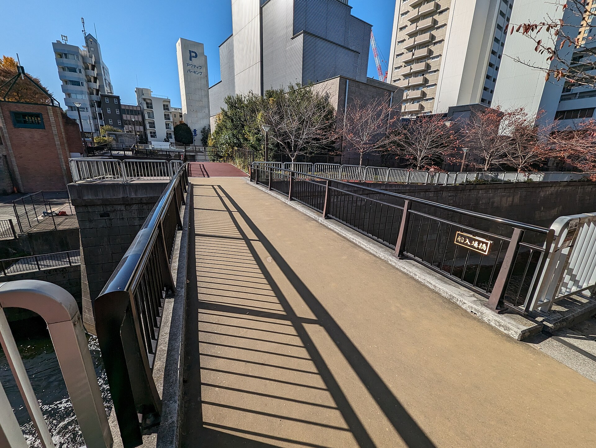 Riverside walking route and low-rise urban buildings along the Meguro River near Nakameguro