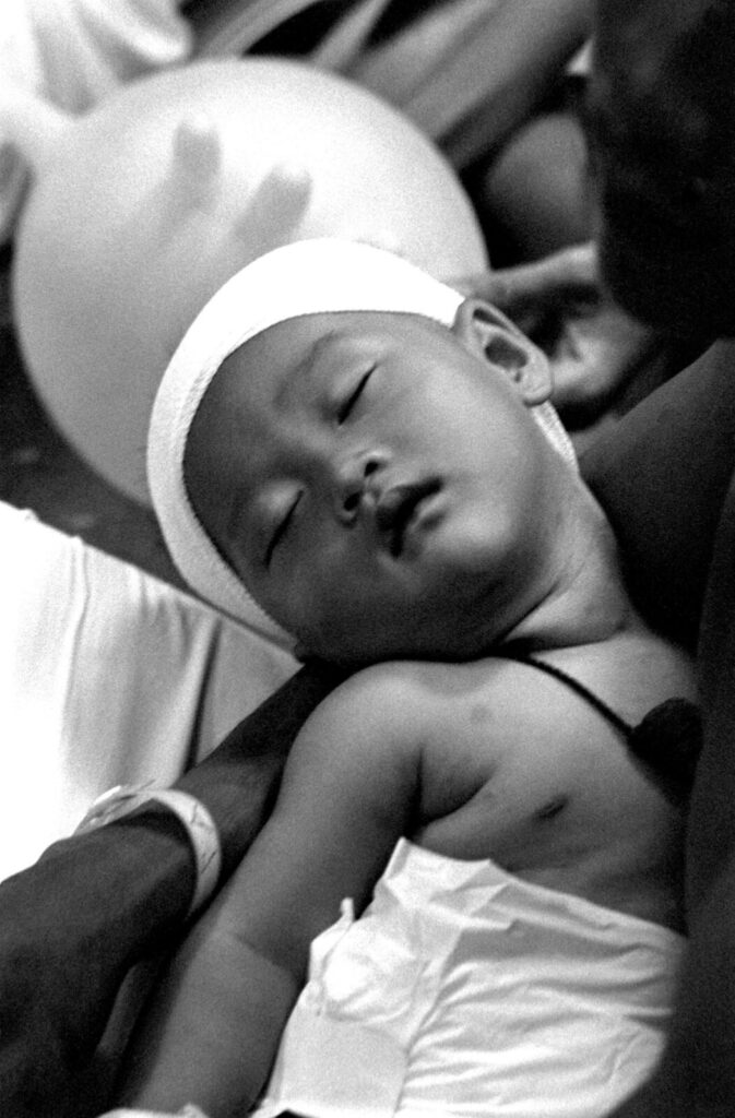 1984年5月、USSブルーリッジ艦上で父親に抱かれて眠る乳児