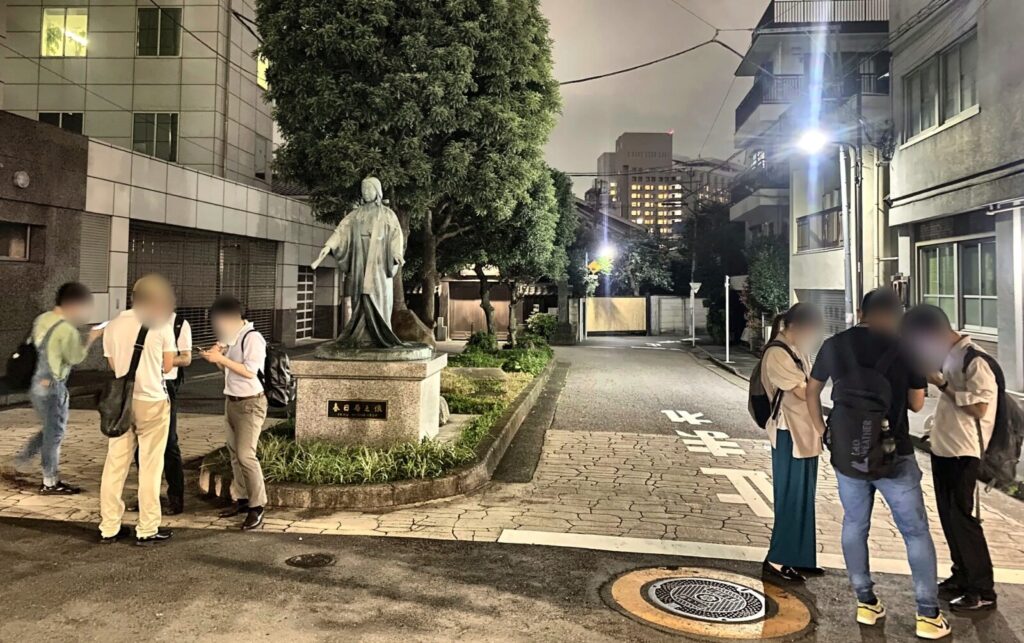 麟祥院前の春日局像付近で散歩を振り返る参加者