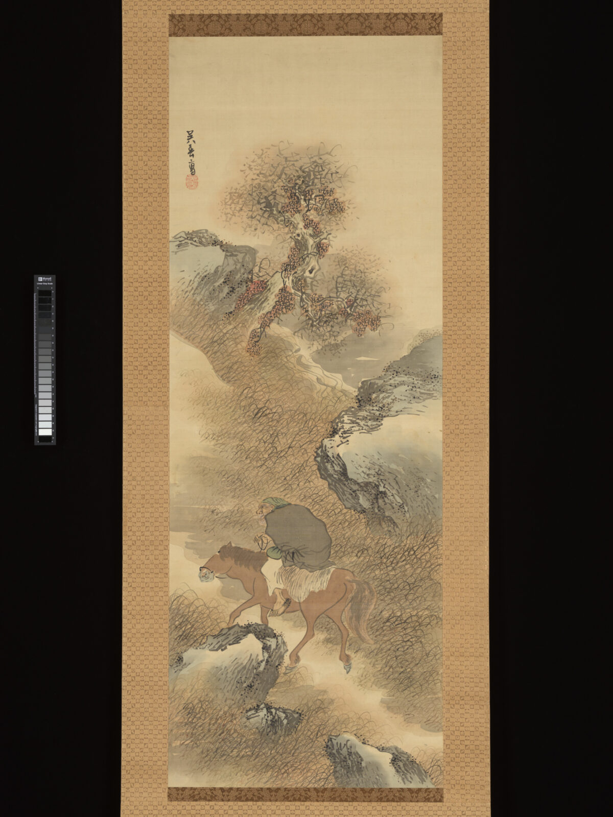 呉春《渓山探薬図》。渓流沿いの山道で白髭の人物が馬に乗り、不老の薬草を探す場面。